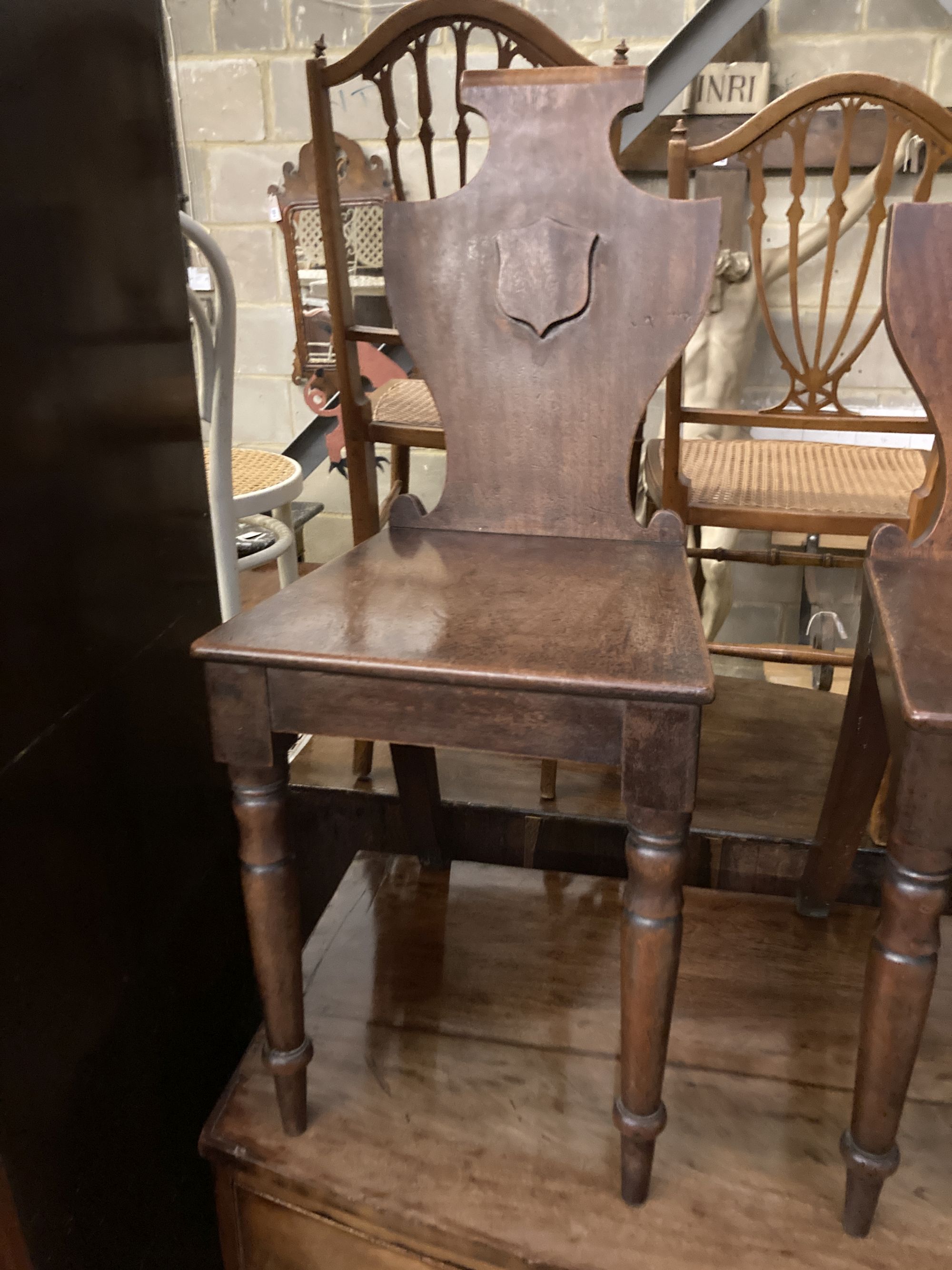 A pair of Victorian mahogany hall chairs